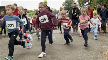 Kinder starten zu einem Lauf, sie tragen Startnummern an ihren Oberteilen