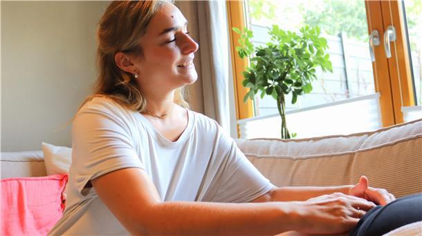 Frau tastet den Bauch einer anderen Frau ab.