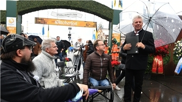 Münchens Oberbürgermeister Dieter Reiter trifft bei der Gedenkveranstaltung für die Opfer des Oktoberfest-Attentats am Denkmal vor dem Haupteingang Betroffene.