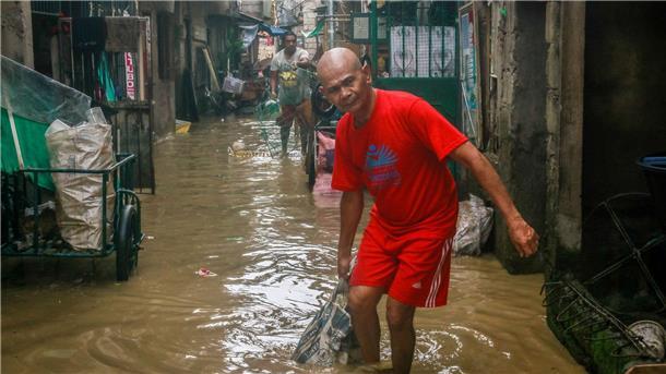 Opfer des Super-Taifuns Noru auf den  Philippinen reinigen ihre Häuser nach den starken Regenfällen.