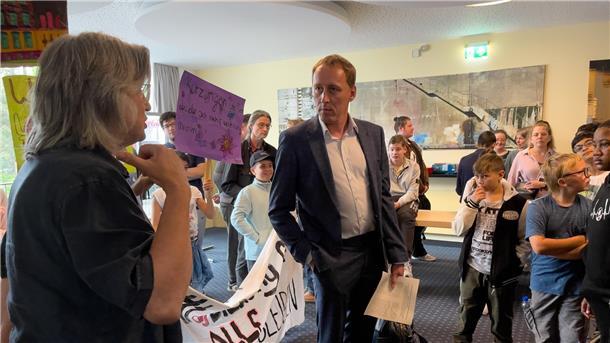 Protestierende haben einen Mann umringt. 