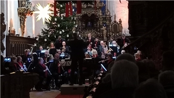 Das Orchester musiziert vor dem Altar in der Kirche.  