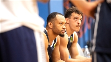 Zwei Basketballer der Eisbären Bremerhaven sitzen auf der Ersatzbank.