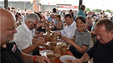 Sichtlich viel Freude findet Niedersachsens Landwirtschaftsministerin Miriam Staudte am Krabbenpulen in Fedderwardersiel. Sie sitzt zwischen Tourismus-Geschäftsführer Claudio P. Schrock-Opitz (vorne rechts) und Butjadingens Bürgermeister Axel Linneweber.