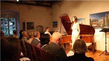 Sopranistin Shireen Derky und Dejan Romih an dem historischen Flügel mit Lieder von Robert Schumann. Davor sitzt Publikum. 