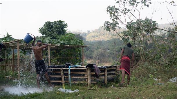 Überleben im Schutz des Dschungels von Myanmar Vertriebene waschen sich in dem Camp im Dschungel von Myanmar.