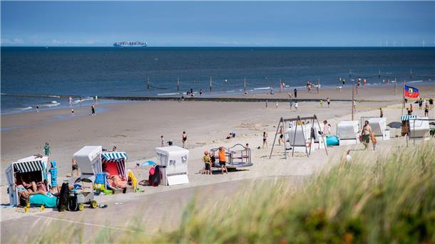 2023 mehr Übernachtungen und Gäste in Niedersachsen Zahlreiche Touristen sitzen bei sonnigem Wetter in Strandkörben am Strand der Insel Wangerooge.