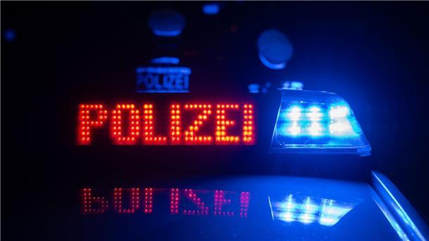 Ermittlungen wegen fahrlässiger Tötung nach Unfall Zwei Polizisten stehen vor einem Polizeifahrzeug (gestellte Szene).